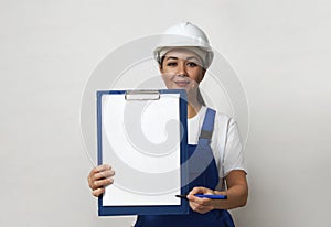 Portrait of young woman worker standing on white background