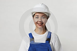 Portrait of young woman worker standing on white background