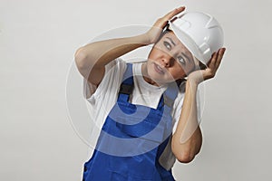 Portrait of young woman worker standing on white background