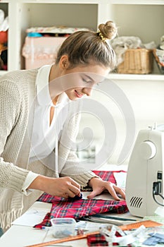 Portrait of a young woman working with a sewing pattern
