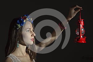 Portrait of a young woman in a wreath of flowers