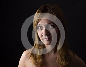 Portrait of young woman on yelllow cole field background