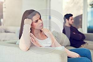 Becoming disconnected. Portrait of a young woman giving her husband the silent treatment after a fight. photo