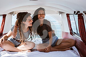 Portrait young women sitting inside of retro van