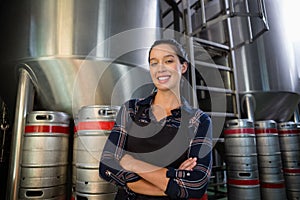 Portrait of young worker standing by storage tank