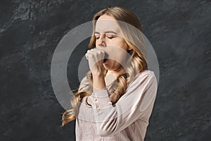 Portrait of young yawning woman