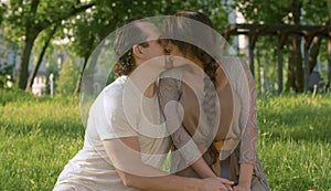 Portraits of beautiful couple kissing in the park