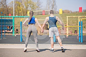 Portraits of a beautiful young athletic couple on the sport place