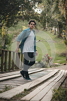 Portraits of boy walking on a bridge photo