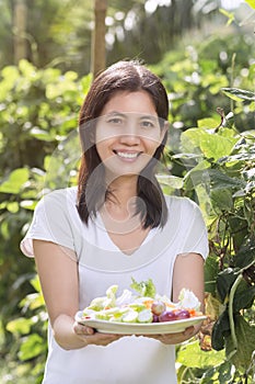 Portraits Cute Asian woman with fresh salad on hand Ready to eat