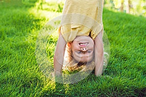 Portraits of happy kids playing upside down outdoors in summer p