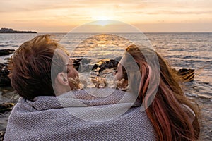 Portraits of lovers, romantic couple of lovers hugging, kissing, touching, eye contact at sunset, sunrise against the