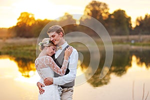 Portraits of a newly married couple. The wedding couple is standing on the background of the order.