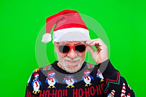 Portrat of old and mature man smiling and looking at the camera wearing christmas clothes  - celebrating xmas photo