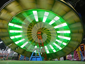 Wipeout Amusement ride night time colourful