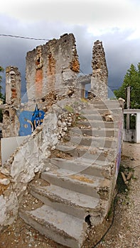 a portrayal of torn houses where only the other stairs are