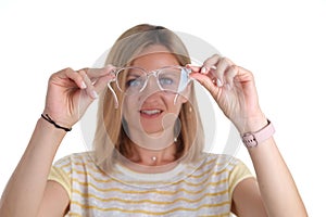 Portre young woman with poor eyesight holds glasses in hands