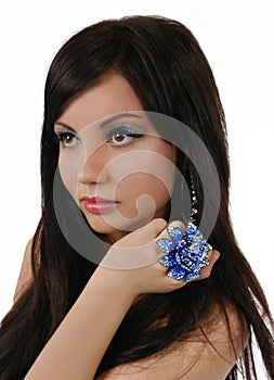 Portret of beautiful brunette with blue ring and b