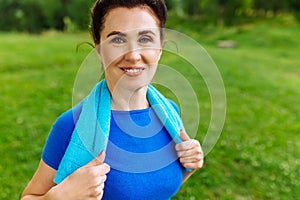 Portret of Senior Woman Exercising In Park. Elderly female doing fitness exercises outdoor. Heathy life style concept