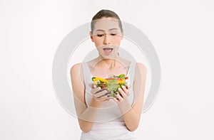 Portriat of beautiful young Asian woman holding a bowl of salad with happy expression holding a bowl of salad with happy