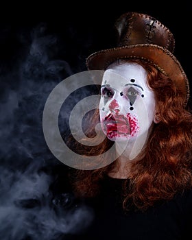 Portriat of a Young woman ins scary clown make up.