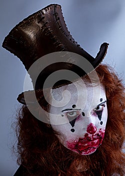 Portriat of a Young woman ins scary clown make up.