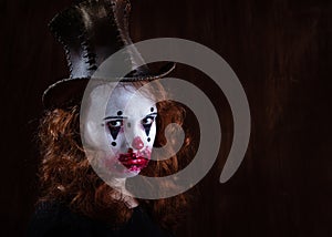 Portriat of a Young woman ins scary clown make up.