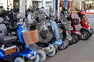 02/06/2020 Portsmouth, Hampshire, UK A row of mobility scooters or disability scooters outside a shop on sale