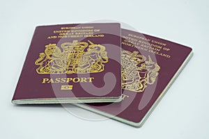 04/23/2020 Portsmouth, Hampshire, UK Two maroon British passports isolated on a white background