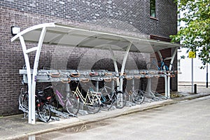 A two teir bike rack with bikes or cycles on both levels photo
