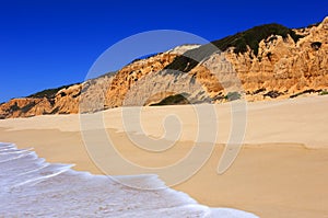 Deserted golden sandy beach in Olhos de Agua, Albufeira, Algarve, Portugal. photo