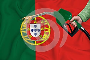 PORTUGAL flag Close-up shot on waving background texture with Fuel pump nozzle in hand. The concept of design solutions. 3d