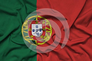 Portugal flag is depicted on a sports cloth fabric with many folds. Sport team banner