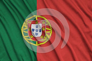 Portugal flag is depicted on a sports cloth fabric with many folds. Sport team banner