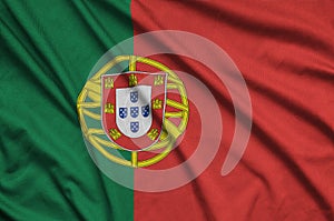 Portugal flag is depicted on a sports cloth fabric with many folds. Sport team banner