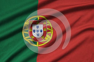 Portugal flag is depicted on a sports cloth fabric with many folds. Sport team banner