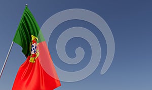 Portugal flag on flagpole on blue background. Place for text. The flag is unfurling in wind. Portuguese. Europe, Lisbon. 3D