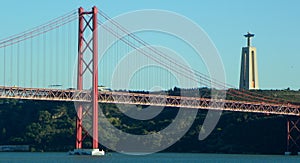 Portugal, Lisbon, Av. BrasiÂ­lia, view of the Christ the King (Santuario de Cristo Rei) and 25th of April Bridge photo