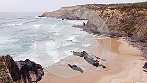 Portugal\'s west coast with sandy beaches and a clear Atlantic Ocean with soft light warming the sand
