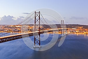 Portugal Travel Destinations. Crossing The Tagus River. Amazing Image of Lisbon Cityscape Along with 25th April Bridge Ponte 25