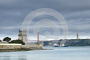 Portugal view of the April 25 bridge and the city of Lisbon across the River Tagus , Rio Tejo, .with ship and view of the statu