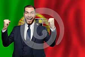 Portugese happy businessman on the background of flag of Portugal Business, education, degree and citizenship concept