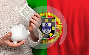 Portugese woman with money bank on the background of Portugal flag. Dotations, pension fund, poverty, wealth, retirement concept