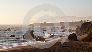 Portuguese beach near Sereno del Mar. Scenic California coastline during sunset with waves crashing onto the rocks photo