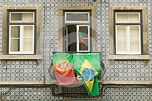 Portuguese and Brazilian flags are displayed from apartment balcony in Lisboa, Lisbon, Portugal, in support of World Cup Soccer