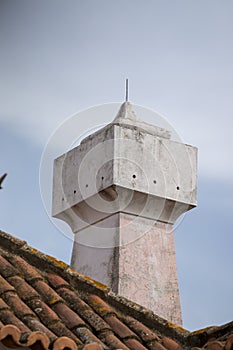 Portuguese chimney on a red tile roof