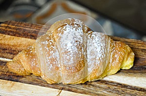 Portuguese croissant with confectioners sugar. photo