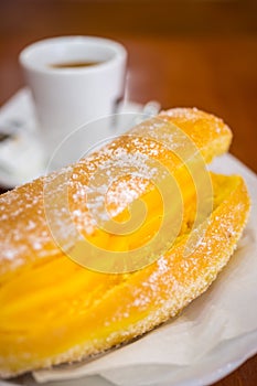 Portuguese Doughnut Or Berliner With Egg Creme And Coffee photo