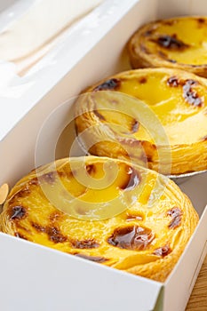 portuguese egg tarts in a box at vertical composition