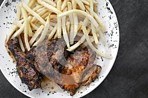 Portuguese famous piri piri spicy bbq chicken with french fries photo